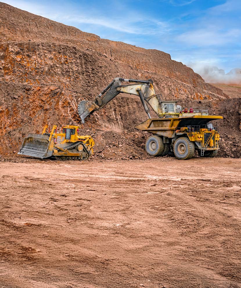 Excavator loading a haul truck in an open-pit mine
